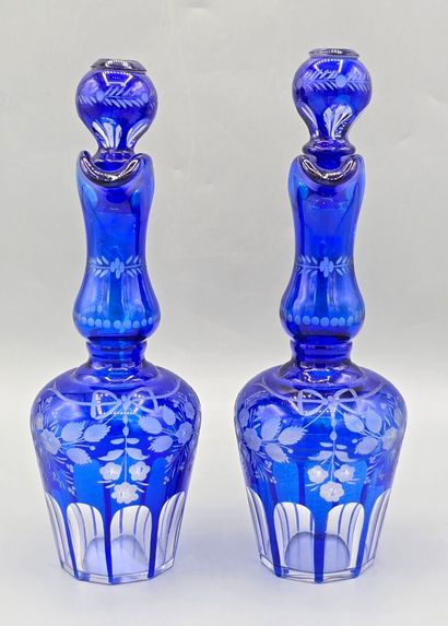 A pair of blue crystal decanters.
Two stoppers...