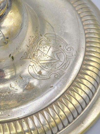 A silver-plated bronze candlestick with a...