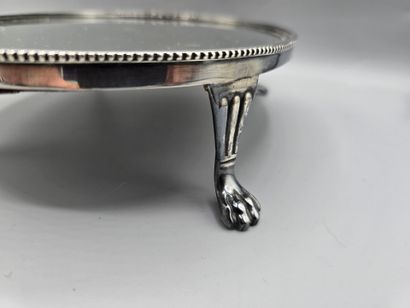 Oval silver-plated metal display tray resting...