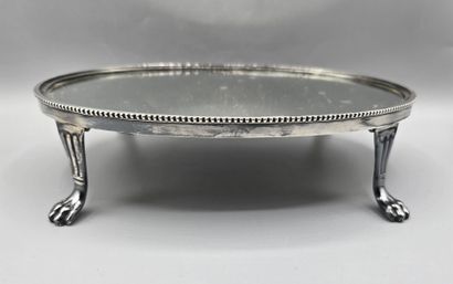 Oval silver-plated metal display tray resting...