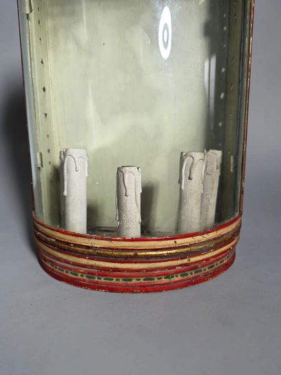 A half-moon-shaped wall sconce with a curved...