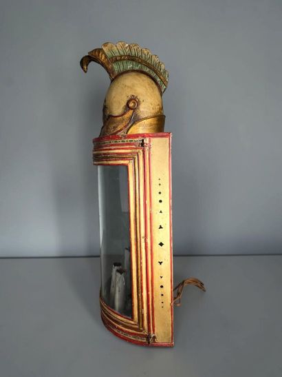 A half-moon-shaped wall sconce with a curved...