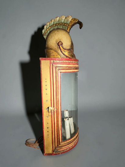A half-moon-shaped wall sconce with a curved...