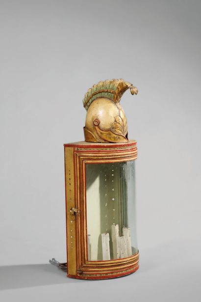 A half-moon-shaped wall sconce with a curved...