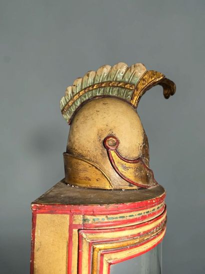 A half-moon-shaped wall sconce with a curved...
