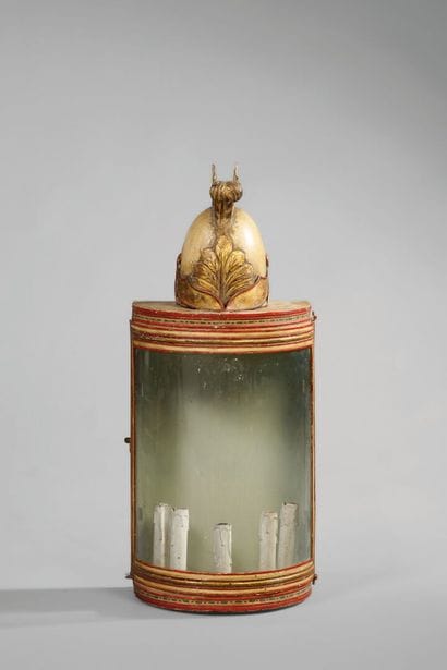 A half-moon-shaped wall sconce with a curved...