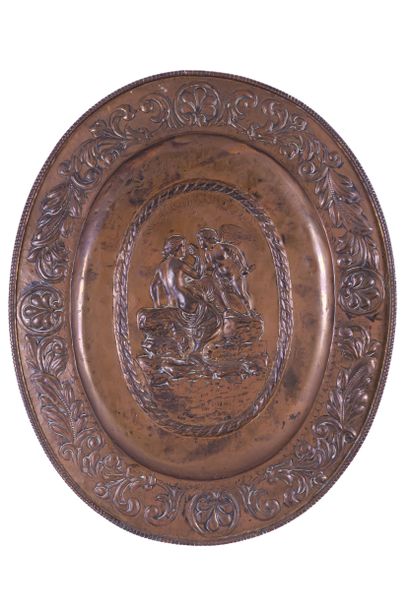Large oval dish in embossed copper, centered...