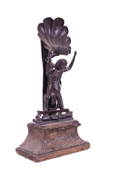 Man with a wrought iron shell on a wooden...