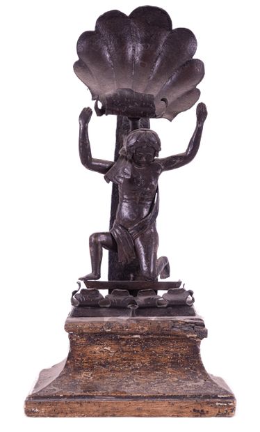 Man with a wrought iron shell on a wooden...
