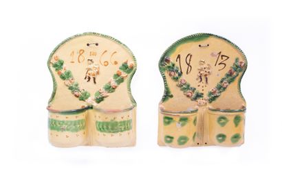 Two varnished earthenware wall planters decorated...