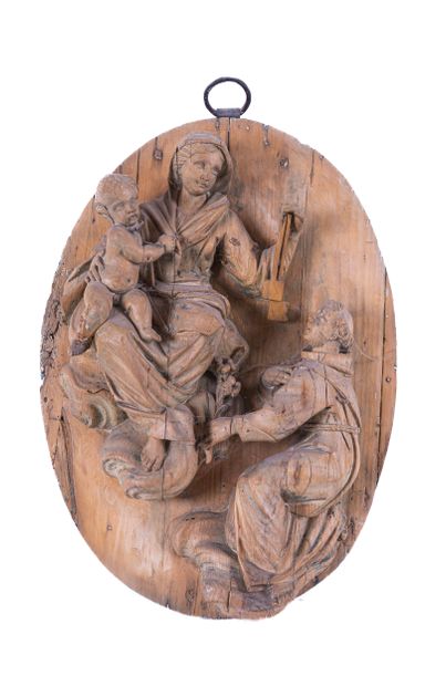 Wooden medallion carved in very high relief...