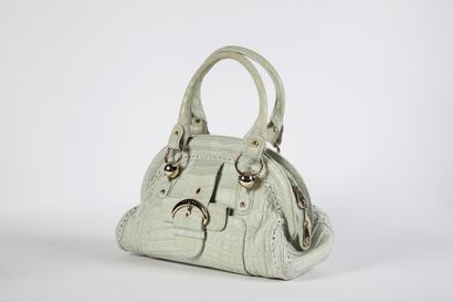 CÉLINE
Water-green reptile-style leather...