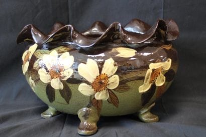 Oval planter with four feet, decorated with...