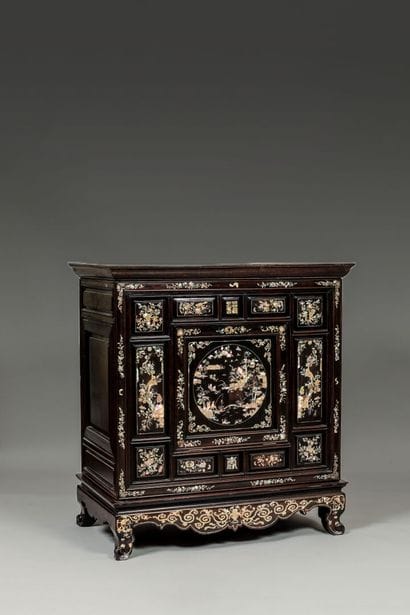 Large cabinet in exotic wood opening by a...