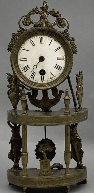 Half-moon clock in chased brass. Enameled...