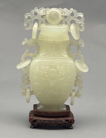 Covered vase of baluster shape in carved...