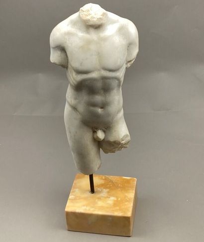 Torso of an acephalous man in sculpted white...