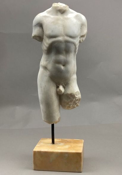 Torso of an acephalous man in sculpted white...