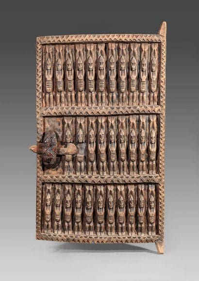 Wooden door of a hut carved with Nommo and...