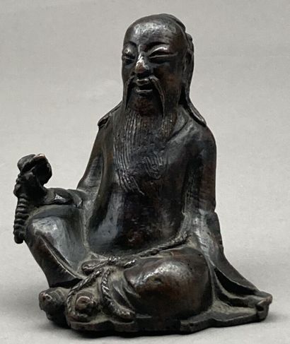 Bronze statuette with brown patina representing...