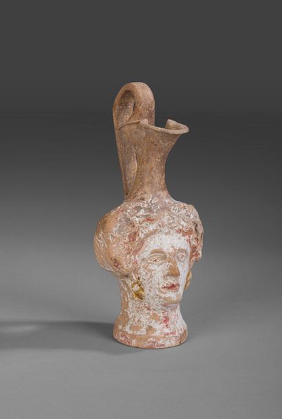 Plastic oenochoe with three-lobed mouth depicting...