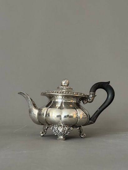Silver quadripod teapot. Blackened wooden...