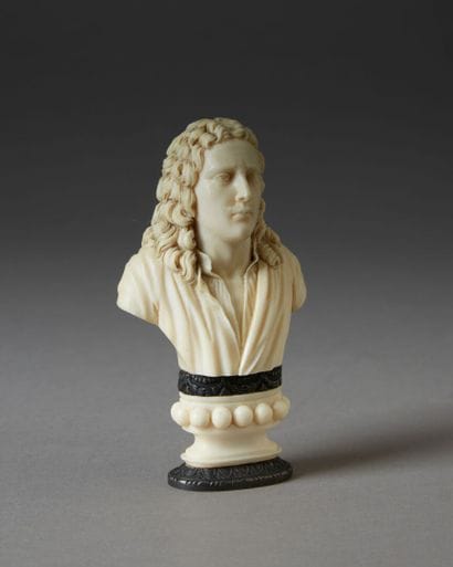 *A finely carved ivory seal featuring a bust...