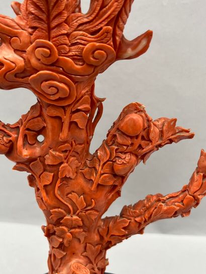 Red coral subject on a wooden base with carved...