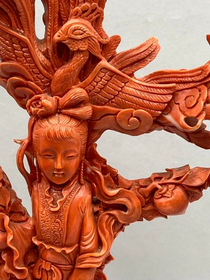 Red coral subject on a wooden base with carved...