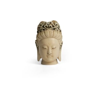 *Carved ivory netsuke featuring a crowned...