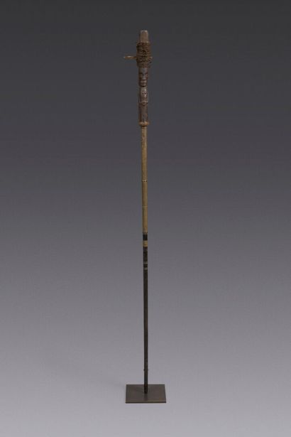 Wooden shaman's cane carved with a figure...