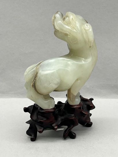 Celadon jade subject depicting a qilin, head...