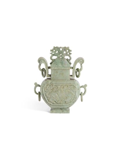 Green hardstone vase presented on a carved...