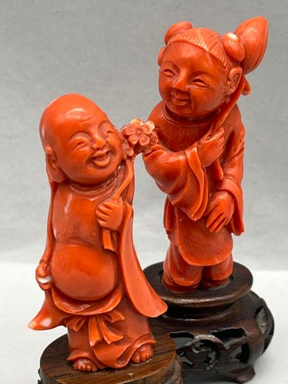 Reunion of two carved red coral subjects,...