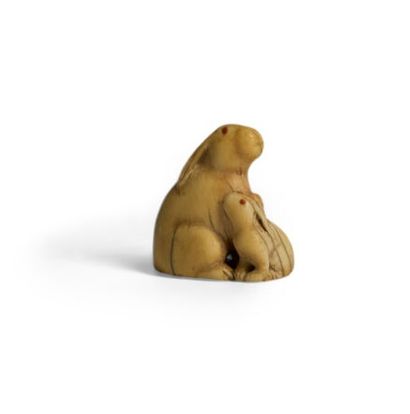 TADAMITSU. 
Ivory netsuke featuring two rabbits...