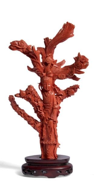 Red coral subject on a wooden base with carved...