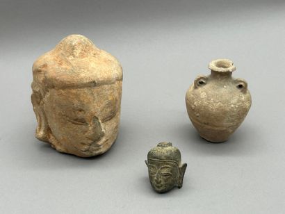 Lot including:
- A stoneware Buddha head,...