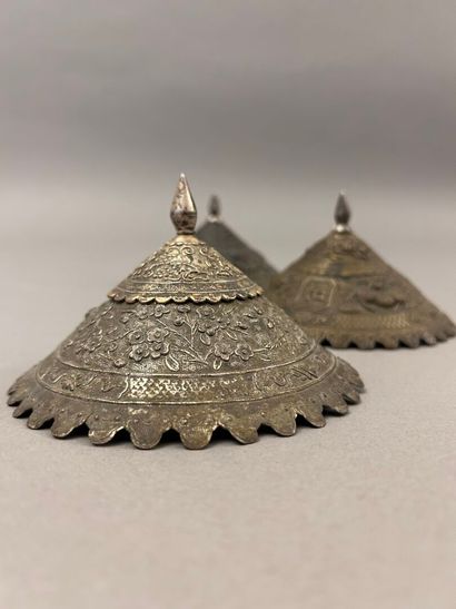 Reunion of three conical metal hat ornaments...