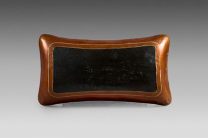 Opium smoker's pillow in lacquered leather....