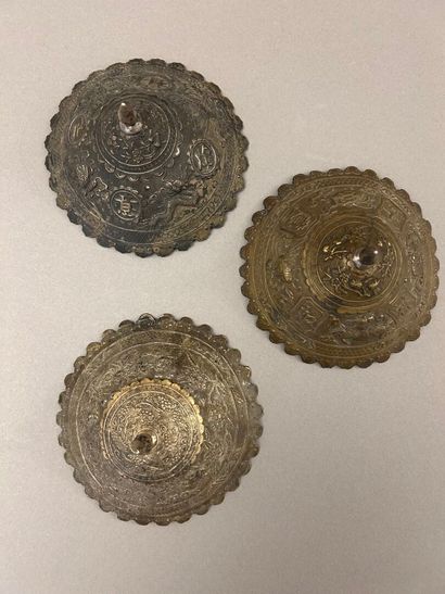 Reunion of three conical metal hat ornaments...