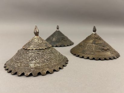 Reunion of three conical metal hat ornaments...