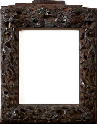 Moulded and carved exotic wood frame. Partially...