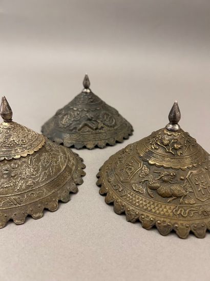 Reunion of three conical metal hat ornaments...