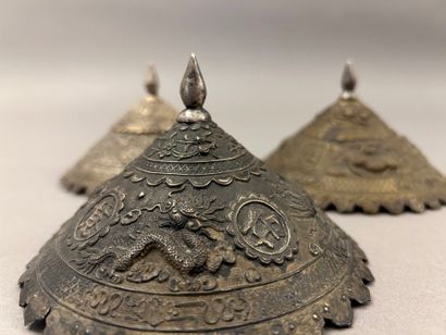 Reunion of three conical metal hat ornaments...