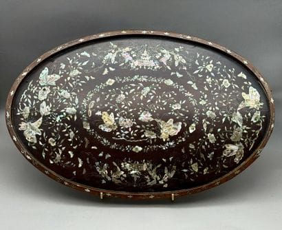 A set of three oval trays made of exotic...