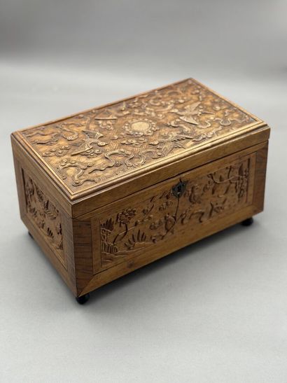 Rectangular wooden box with carved decorations...