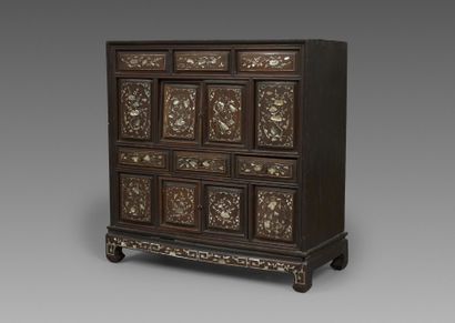 A small cabinet with multiple compartments,...