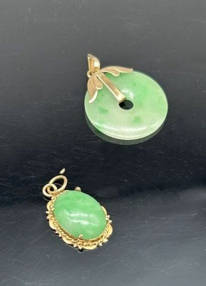 Pendant featuring an oval jadeite cabochon...