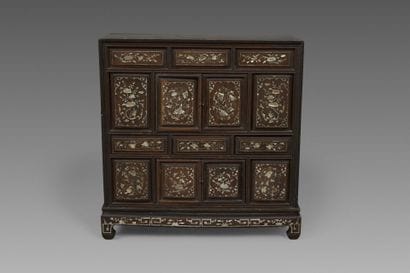 A small cabinet with multiple compartments,...