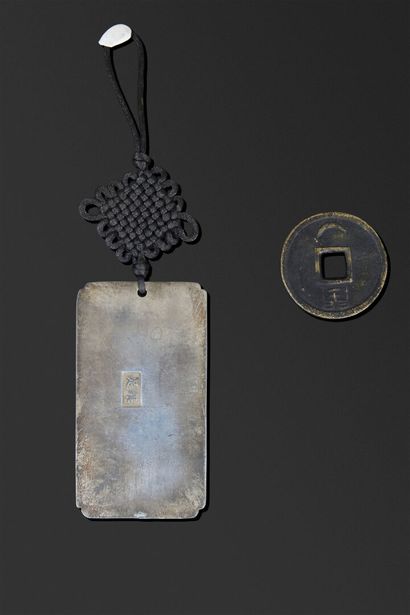 A rectangular plaque with beveled edges,...